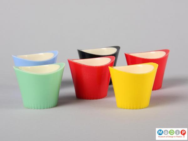 Side view of six Paramount egg cups showing the oval shape and the raised sides of the egg cup.