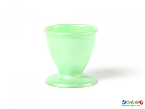 Side view of a green Empire egg cup showing its fluted foot at the base.