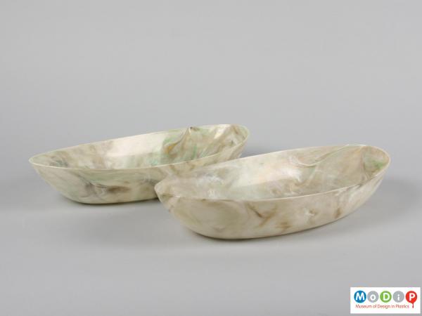 Side view of a pair of oval fruit bowls showing the straight sides.