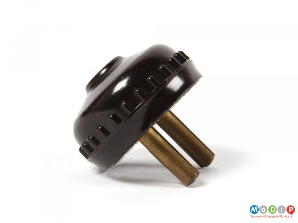 Side view of a 2-pin plug showing the metal pins and the moulded top.