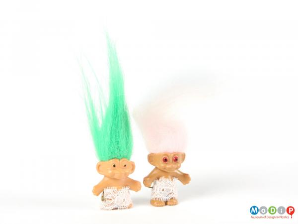 Front view of 2 trolls showing the long green and pale pink hair.