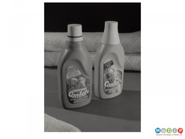 Scanned image showing two bottles of comfort with blankets in the background.