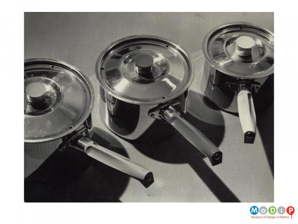 Scanned image showing a range of saucepans.