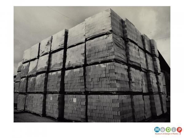 Scanned image showing stacks of pallets loaded with shrink wrapped bricks.