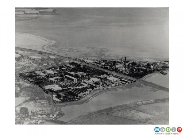 Scanned image showing an aerial view of a factory.