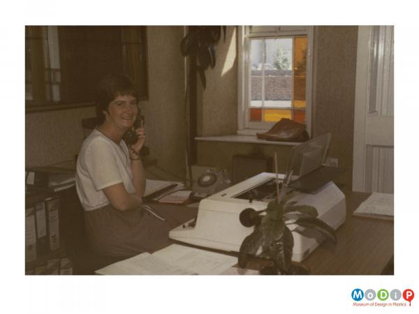 Scanned image showing a female office worker.