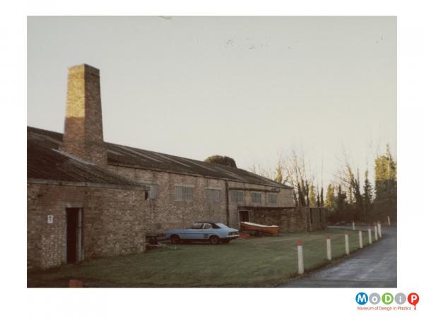 Scanned image showing an exterior view of factory buildings.