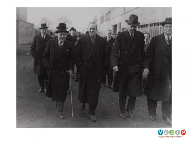 Scanned image showing a group of smartly dressed men.