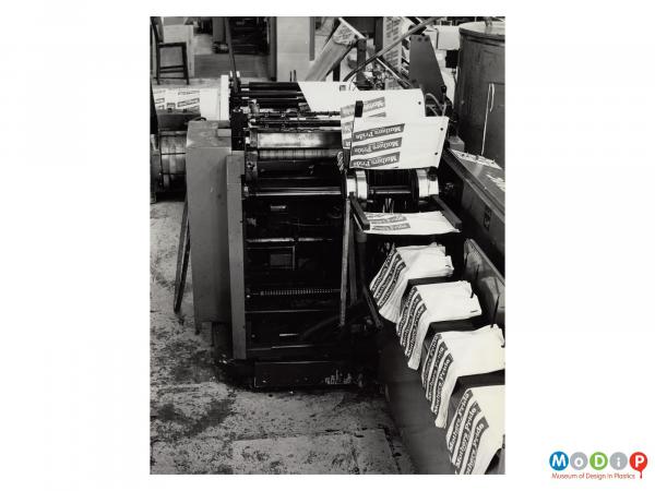 Scanned image showing a machine sorting bread bags.