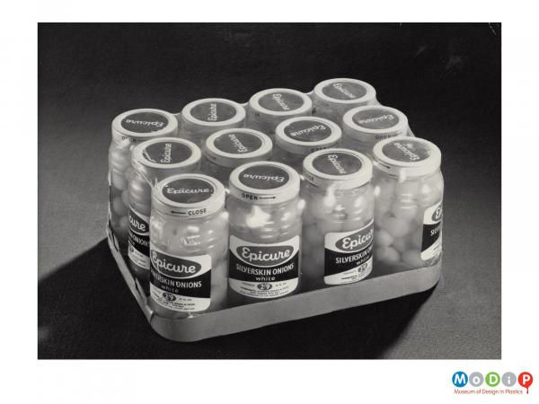 Scanned image showing a shrink wrapped crate of Silver Skin Onion jars.