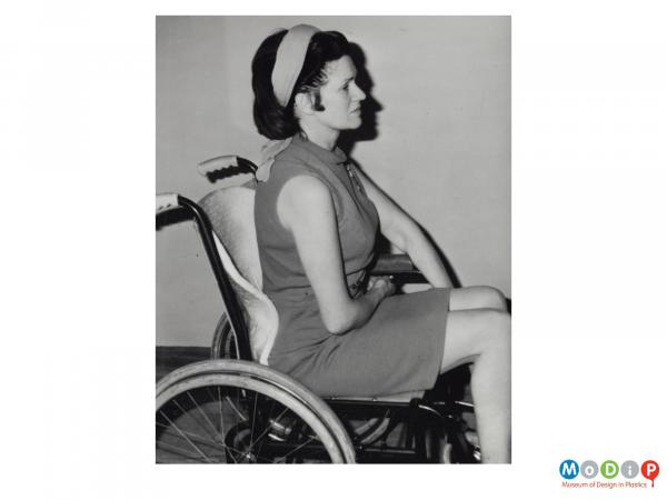 Scanned image showing a woman in a wheel chair.