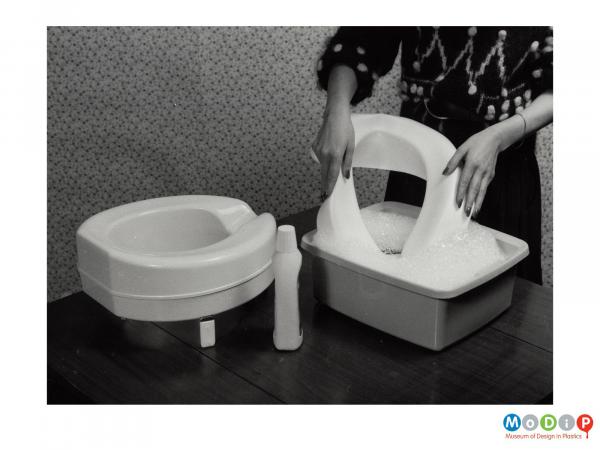 Scanned image showing a toilet seat cover.