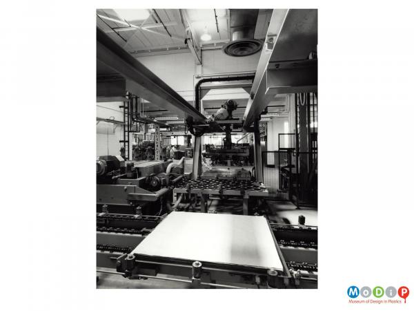 Scanned image showing sheet material on a production line.