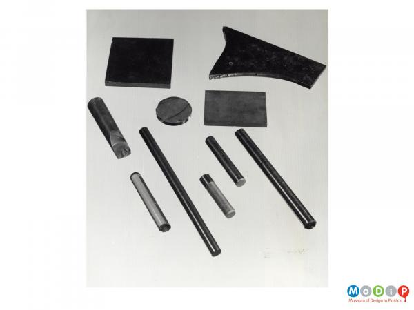 Scanned image showing a group of rods and flat samples.