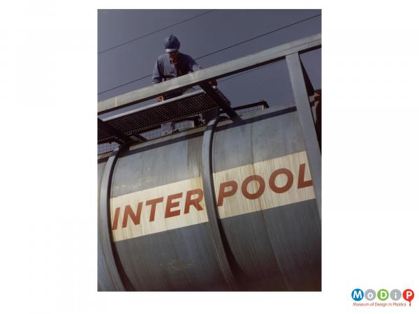 Scanned image showing a man on top of a tanker.