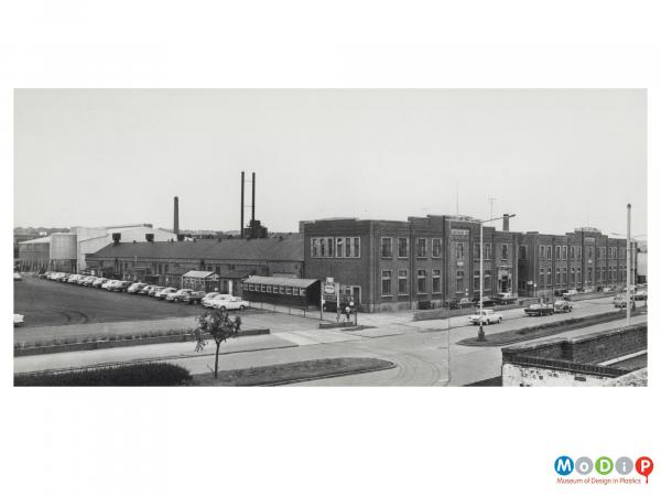 Scanned image showing an external view of a factory building.
