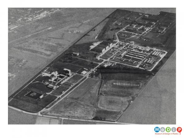 Scanned image showing an aerial view of factory buildings.