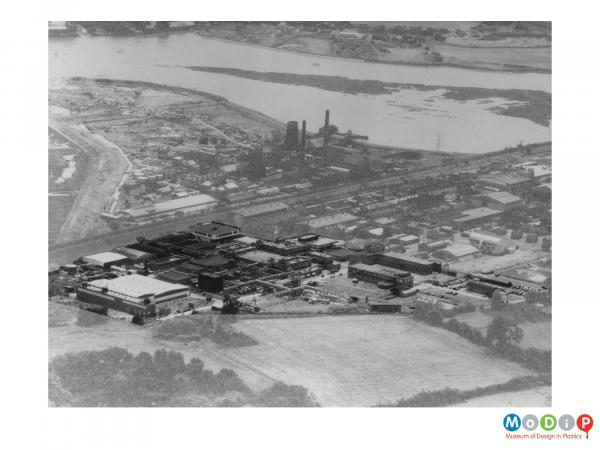 Scanned image showing an aerial view of factory buildings.