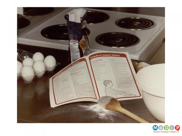 Scanned image showing a baking scene including a clear plastic egg box.