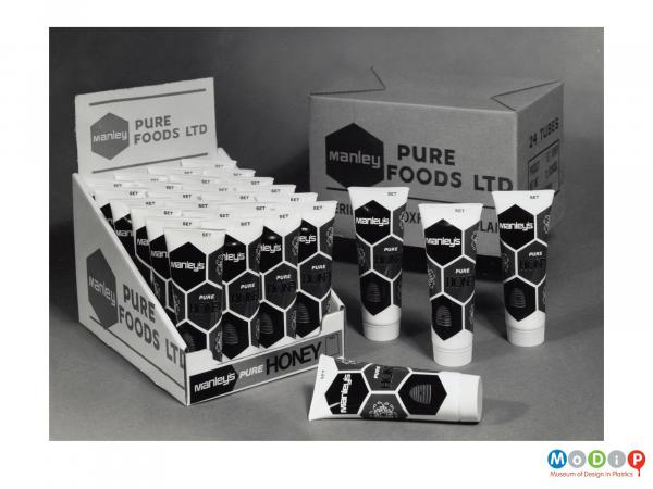 Scanned image showing a box of tubes of honey.