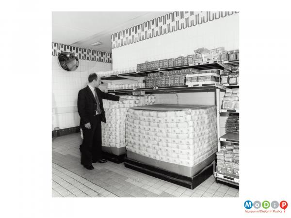 Scanned image showing a man in a supermarket.