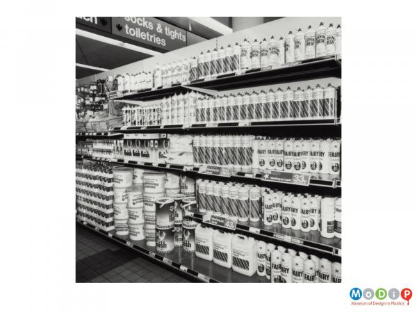 Scanned image showing washing up bottles in a supermarket.