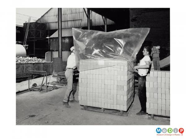 Scanned image showing a polythene bag covering a stack of bricks prior to being shrunk.