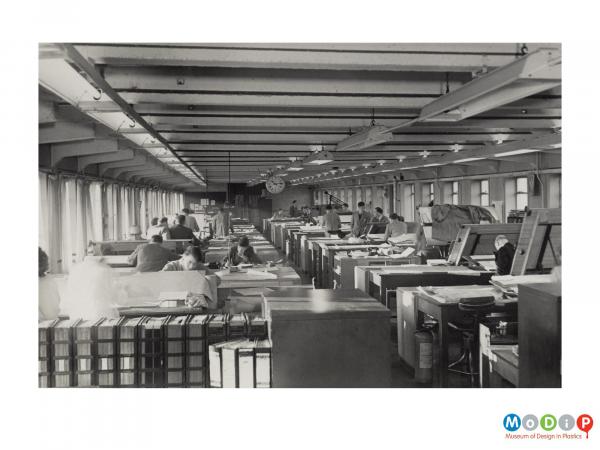 Scanned image showing a group of people in a design studio.