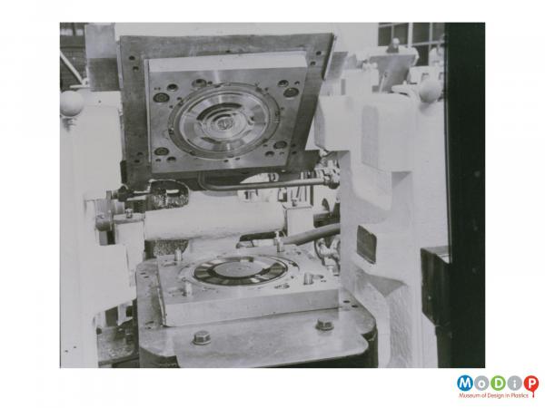 Scanned image showing a record pressing machine.