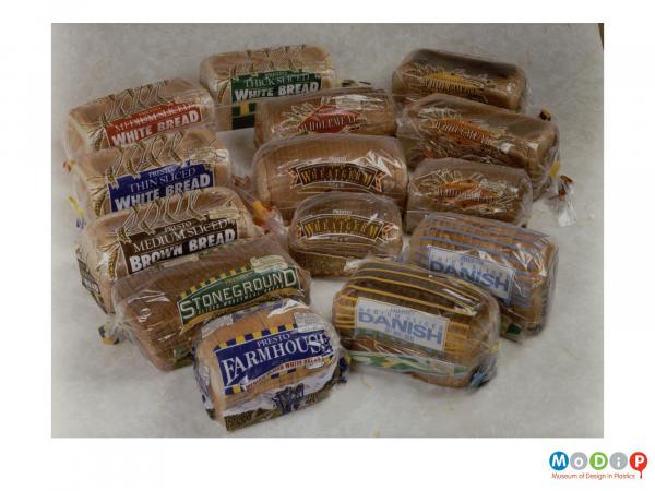 Scanned image showing a range of 14 breads contained within clear plastic bags.