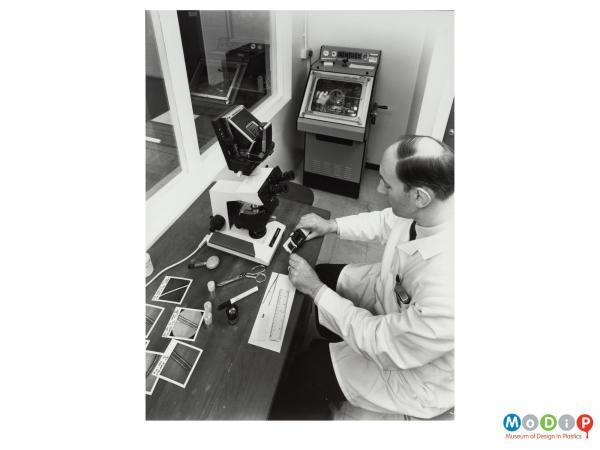 Scanned image showing a male employee in a laboratory.