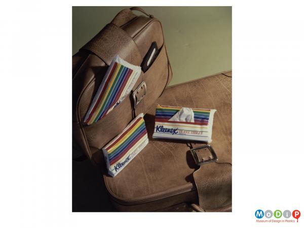 Scanned image showing packets of travel tissues alongside luggage.