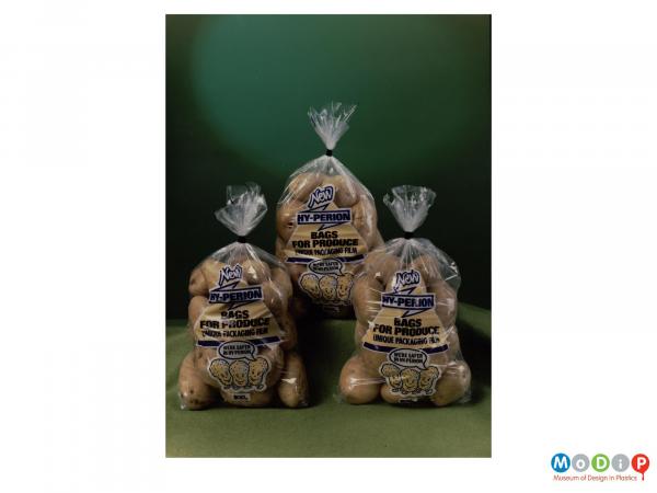 Scanned image showing three sacks of potatoes.