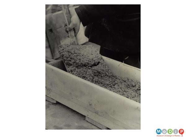 Scanned image showing a concrete mould being filled.