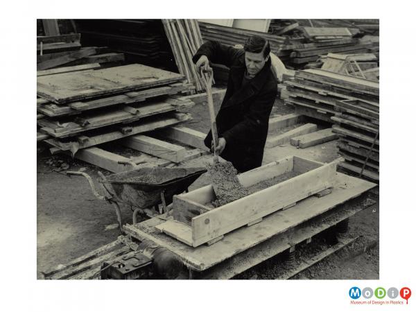 Scanned image showing concrete moulds being filled.