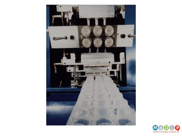 Scanned image showing a production line of transparent cylinders.