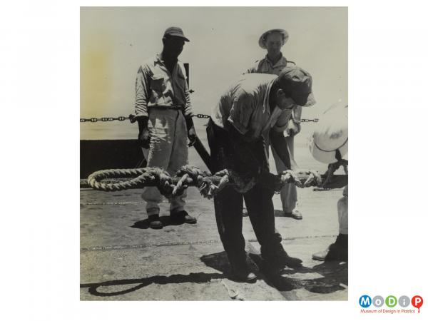 Scanned image showing rope temporarily securing an electrical cable for a oil rig.