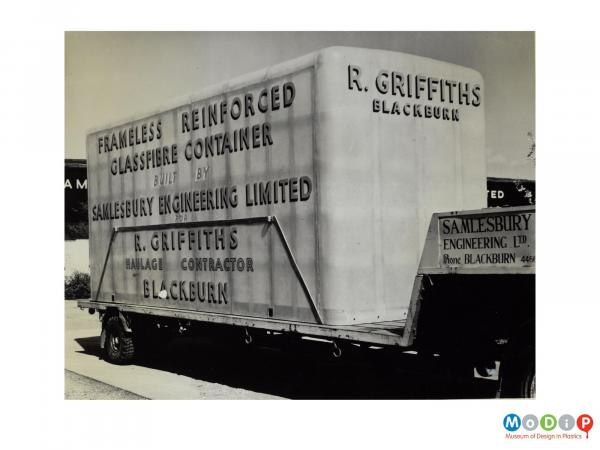 Scanned image showing a container on the back of a lorry.
