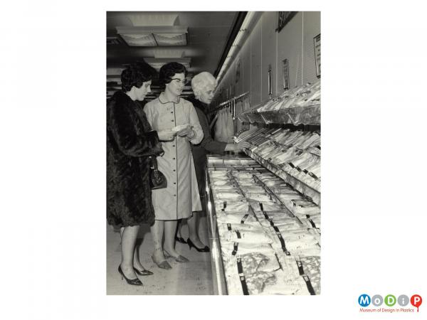 Scanned image showing shoppers in a supermarket.