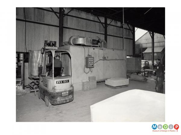 Scanned image showinga pallet load of bricks being loaded into a shrink wrapping machine.