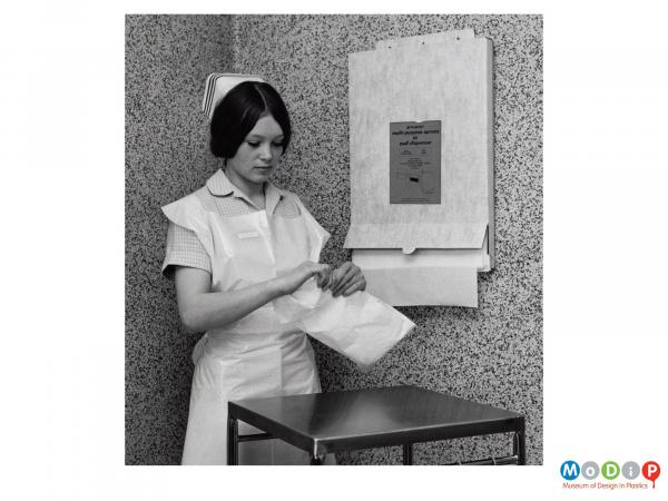 Scanned image showing a nurse wearing a disposable apron.