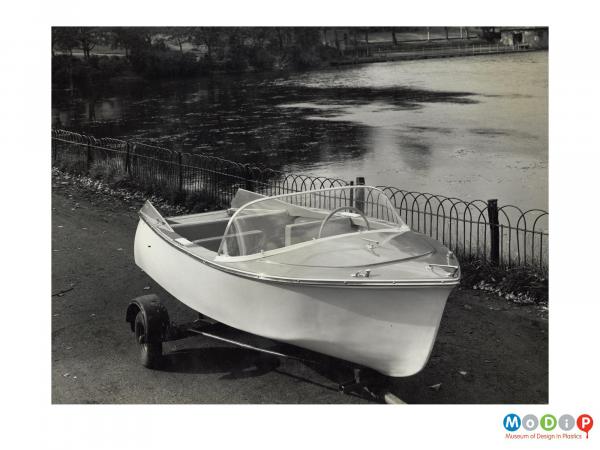 Scanned image showing a small motor boat on a trailer