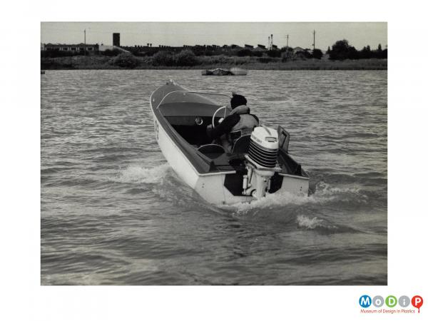Scanned image showing a small motor boat on the water.