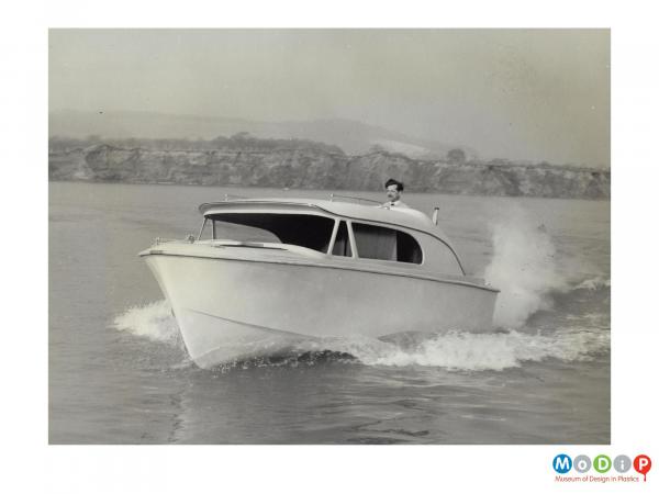 Scanned image showing a motor boat on the water.
