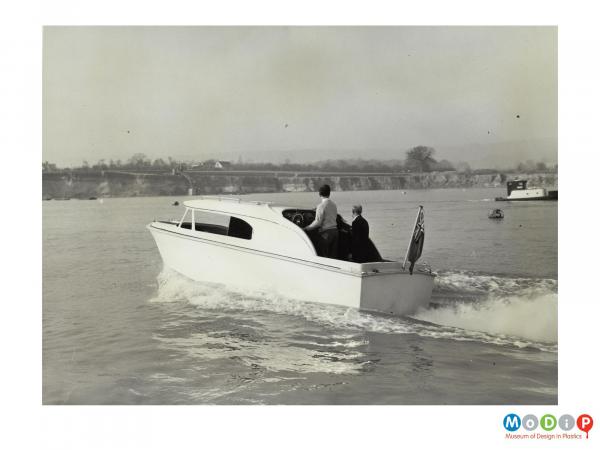 Scanned image showing a motor boat on the water.