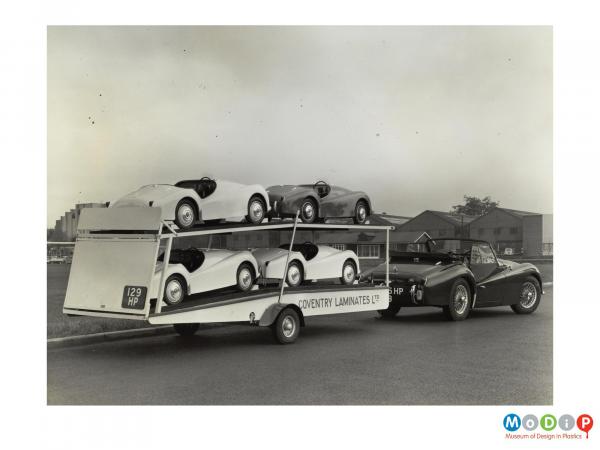 Scanned image showing Junoir cars on a small transporter.