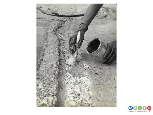 Scanned image showing the repair of a crack in a road surface.