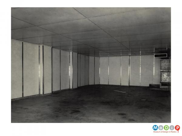 Scanned image showing a large room with wall panels.