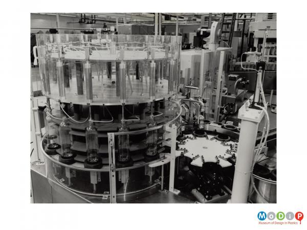 Scanned image showing bottles on a production line.