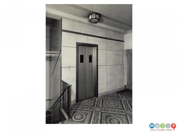 Scanned image showing wall panels in a lift lobby.